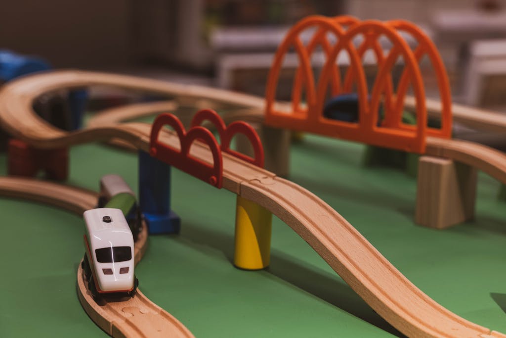 Close-up of a vibrant wooden toy train track featuring bridges and curves. Ideal for children's play.