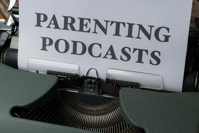 Close-up of a vintage typewriter with a sheet titled 'Parenting Podcasts'.