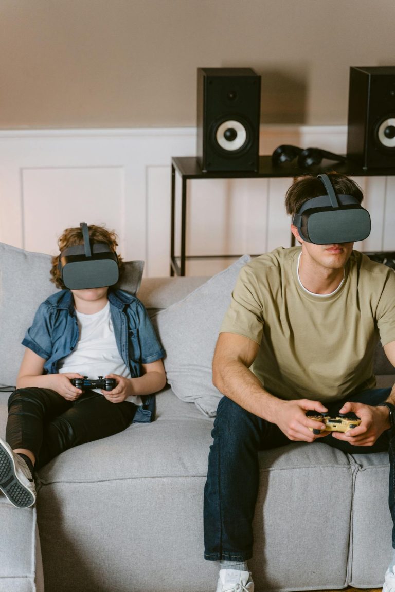 Father and child deeply immersed in virtual reality gaming on a cozy sofa.