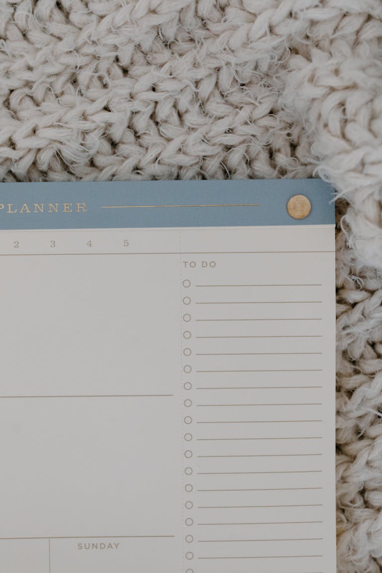Flat lay photograph of a minimalist to-do planner on a textured background.